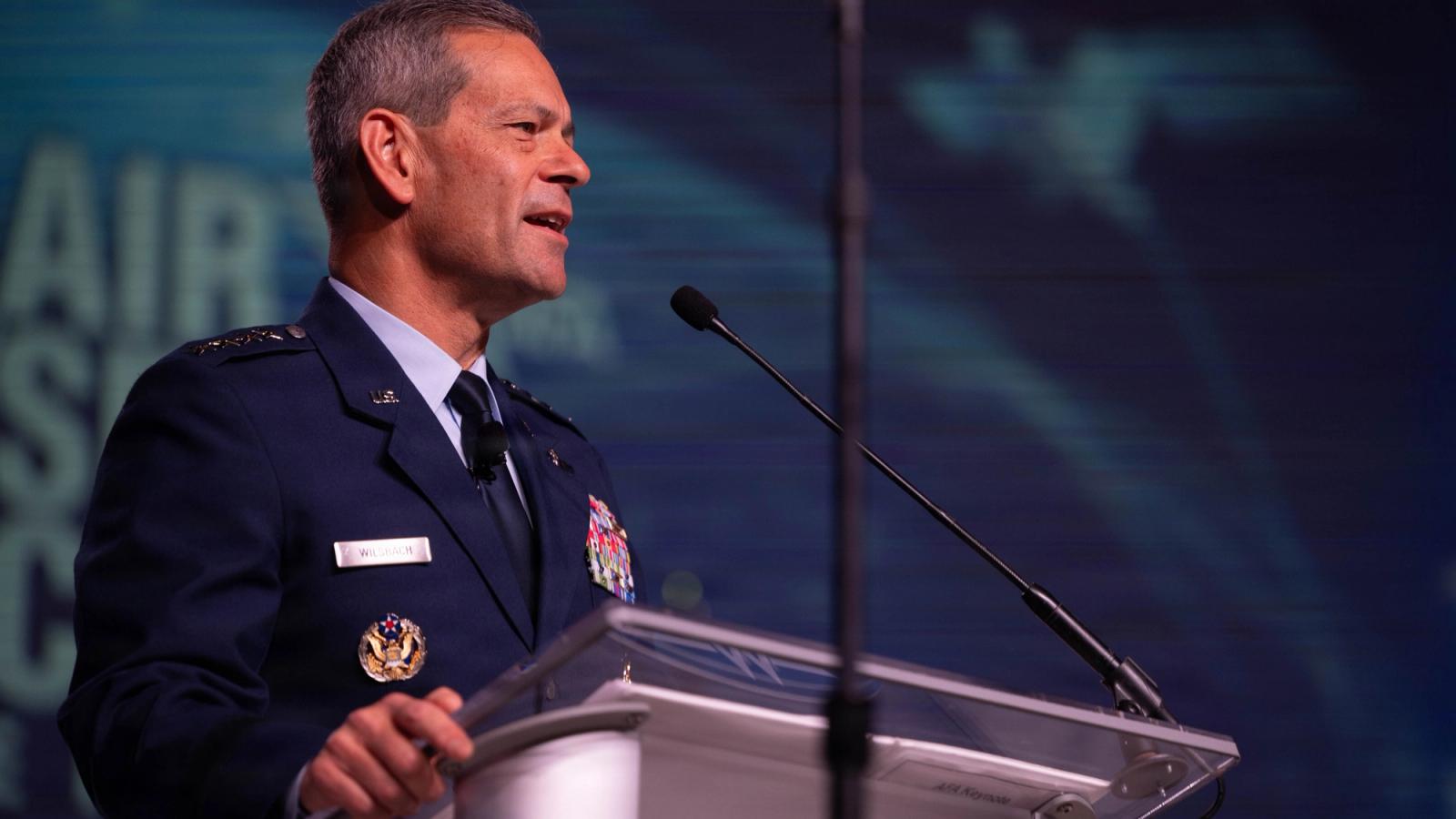 A General speaks at a podium at a conference.