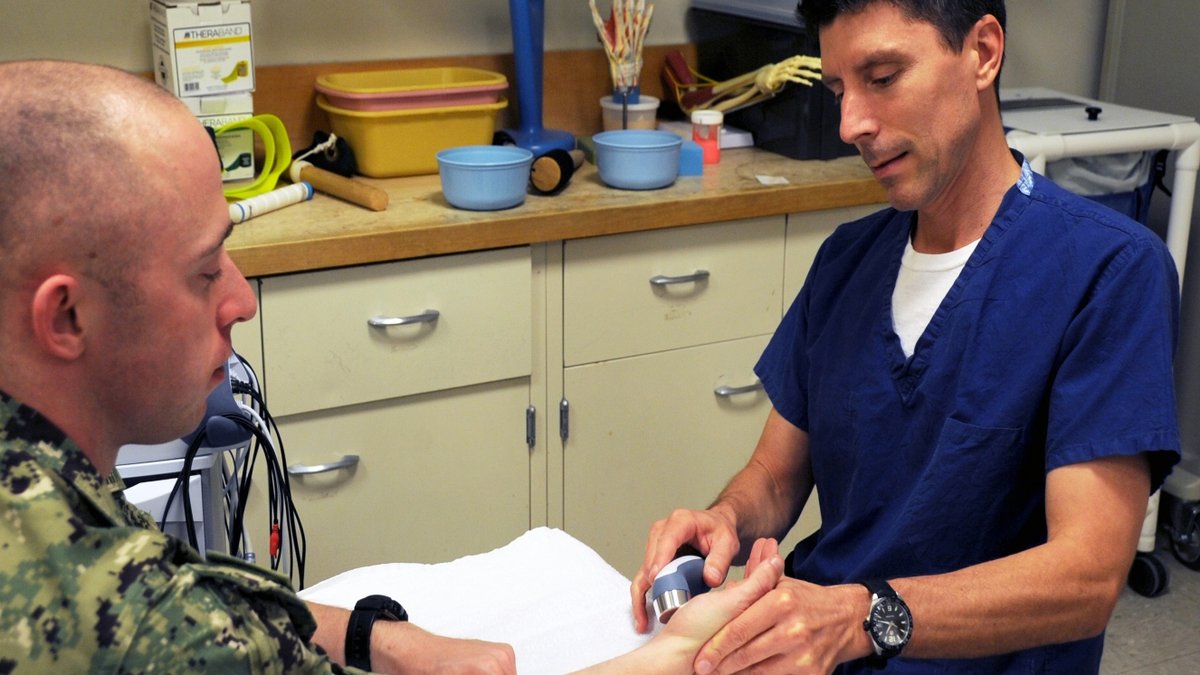 A doctor examines a soldier.