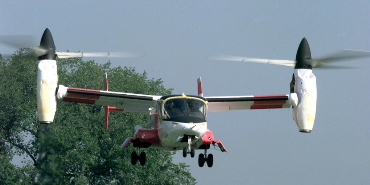 Bell V-22 Osprey in flight with trees in the background at Fort Worth.