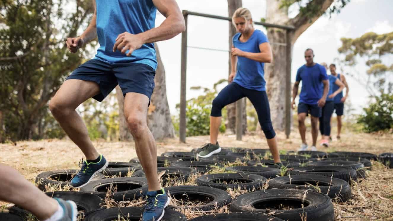 People completing a tire exercise course.