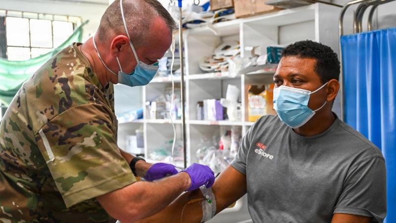 U.S. Air Force Master Sgt. Michael Bell, 445th Aerospace Medicine Squadron medical technician, removes an IV from a patient in the emergency room.