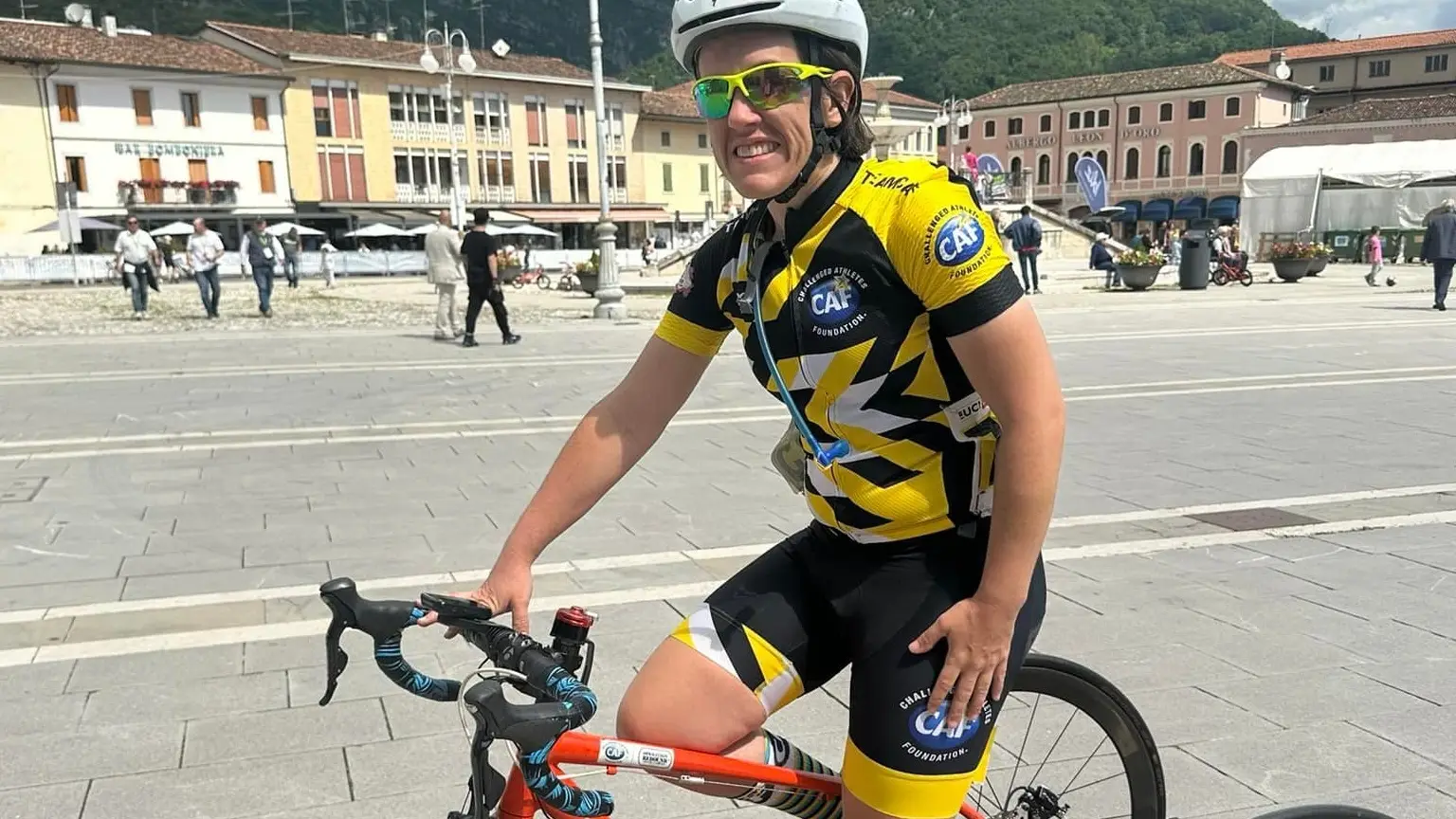 A paracyclist stops to pose for a picture.