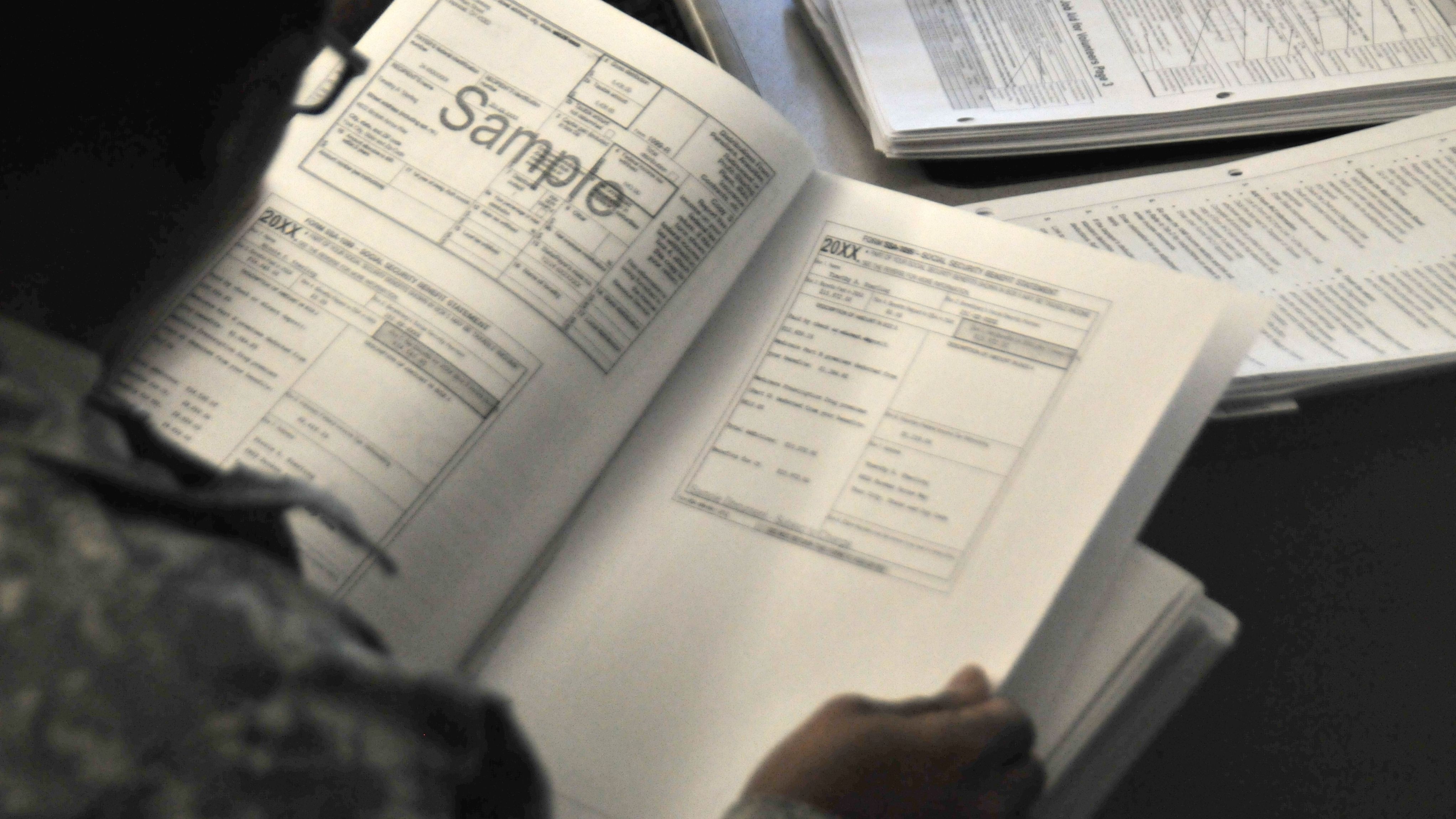 A soldier reads through tax forms.