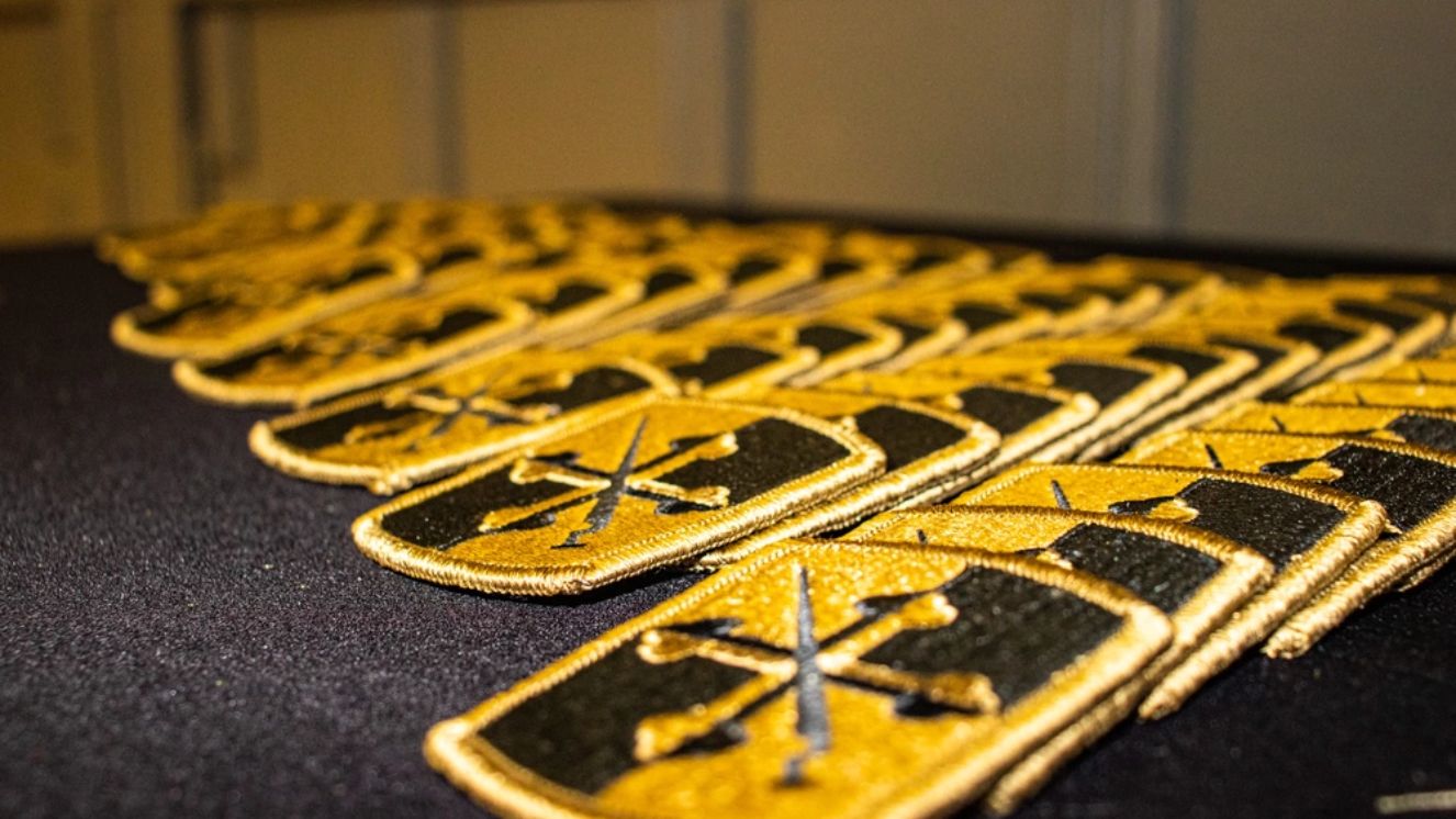 Velcro patches of the 58th Expeditionary Military Intelligence Brigade await use at the 110th Information Operations Patch-Over ceremony at Camp Fretterd Military Reservation in Reisterstown, Md.