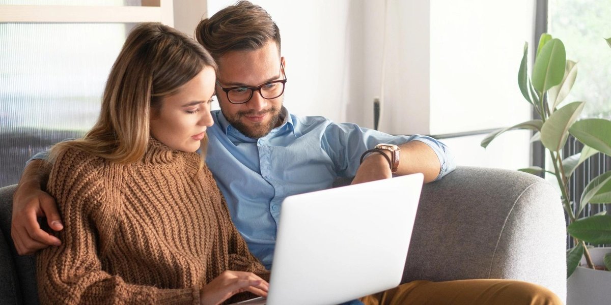 Couple reviewing TRICARE health coverage options on a laptop at home
