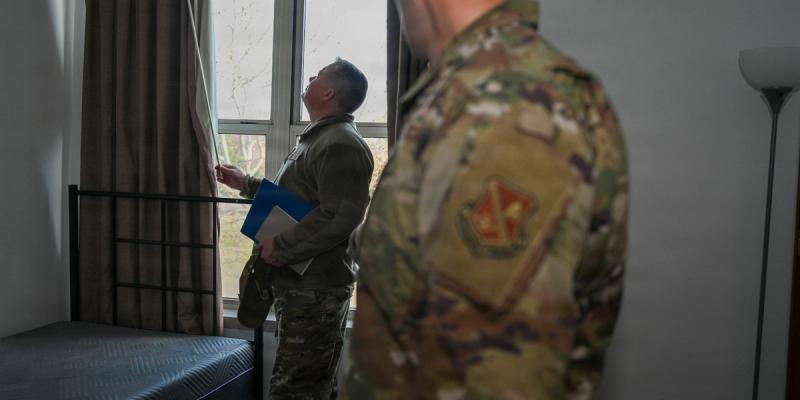 Airman Joseph Toler (left) from the 27th Special Operations Wing, participating in a tour of new apartment options in Clovis, New Mexico. The event, titled "Wings and Walls," was organized to help Airmen find affordable housing off-base following a change in Air Force policy regarding Basic Allowance for Housing (BAH).