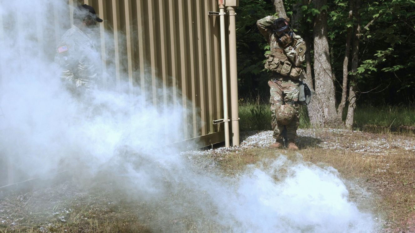 A U.S. Army soldier assigned to the Army Materiel Command donned a protective gas mask during a simulated toxic gas exposure in the warrior task element of the U.S. Army Contracting Command's Best Warrior Competition, May 6-10 at Redstone Arsenal, Alabama.