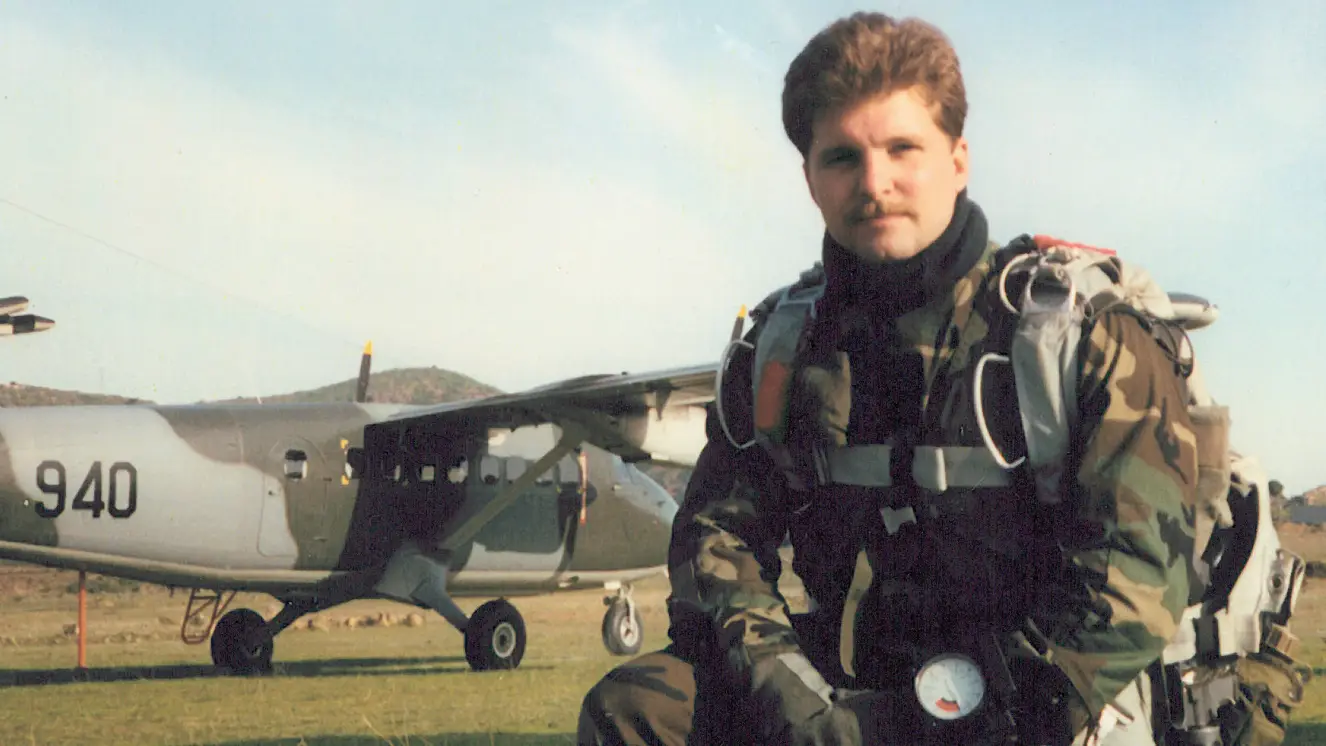Chapman geared for a parachute jump.