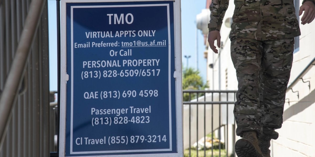 A U.S. Air Force Airman walks past a sign at the 6th Logistics Readiness Squadron Traffic Management Office entrance at MacDill Air Force Base, Florida, May 26, 2021. Any military member who is retiring, separating or changing duty stations will work with TMO, specifically personal property and passenger travel, to get their personal belongings shipped to their next home. (U.S. Air Force photo by Staff Sgt. Heather Fejerang)