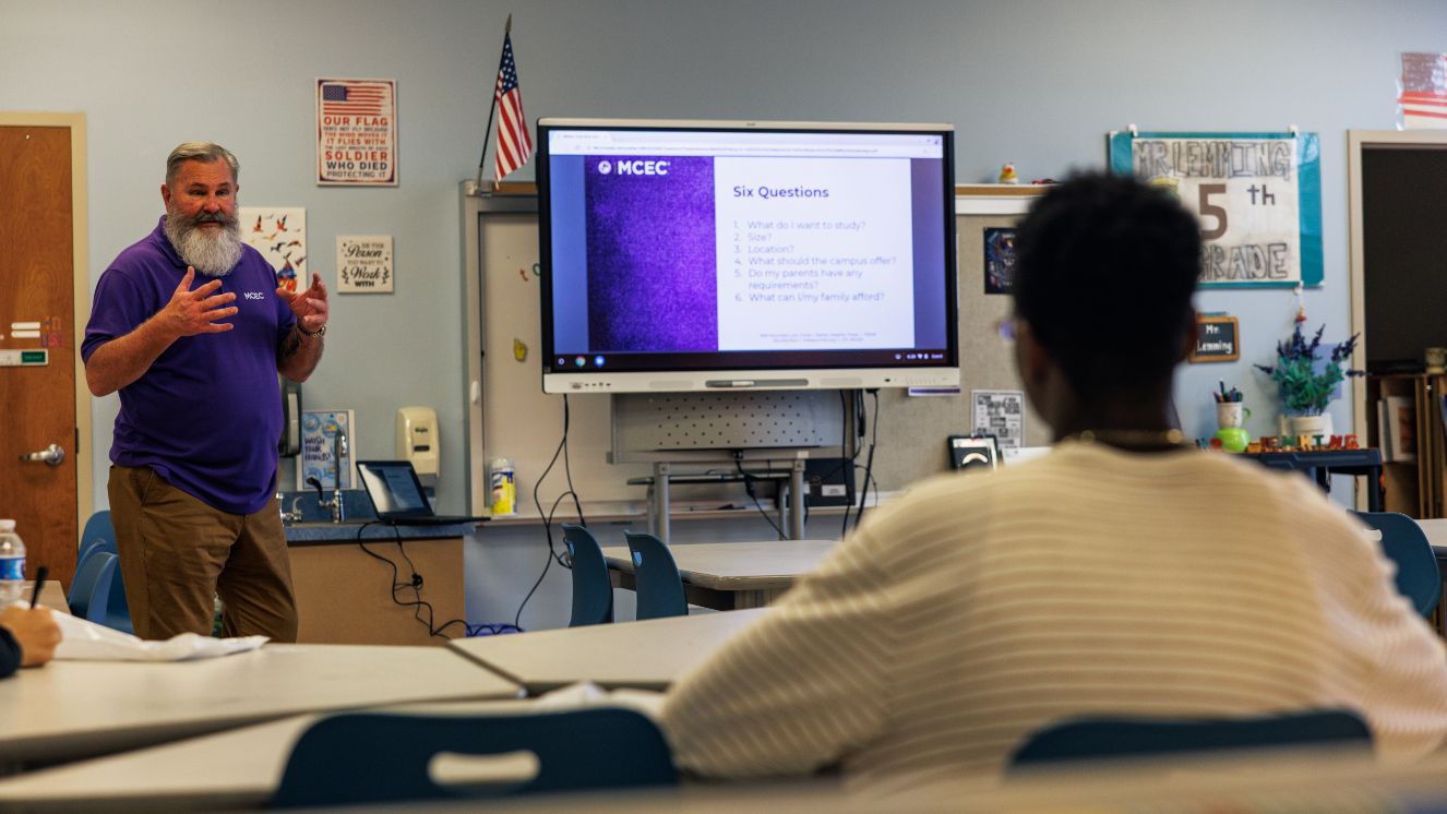 Students sit in a classroom during a presentation.