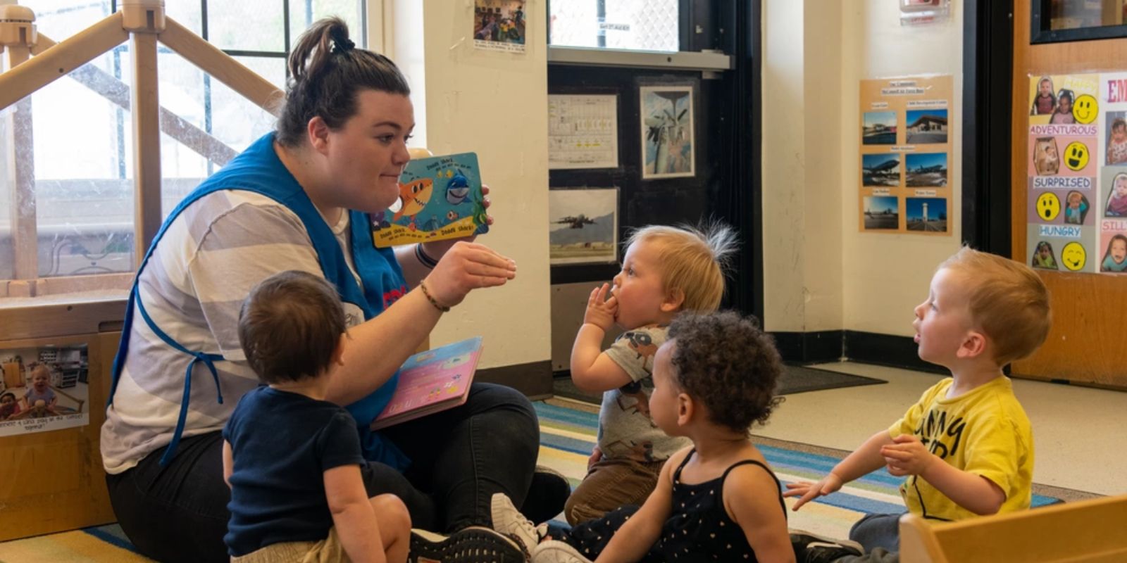 A Childcare Development Center childcare provider reads a story to children April 11, 2023, at McConnell Air Force Base, Kansas. 