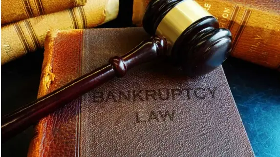 Still life of gavel and book of Bankruptcy Law.