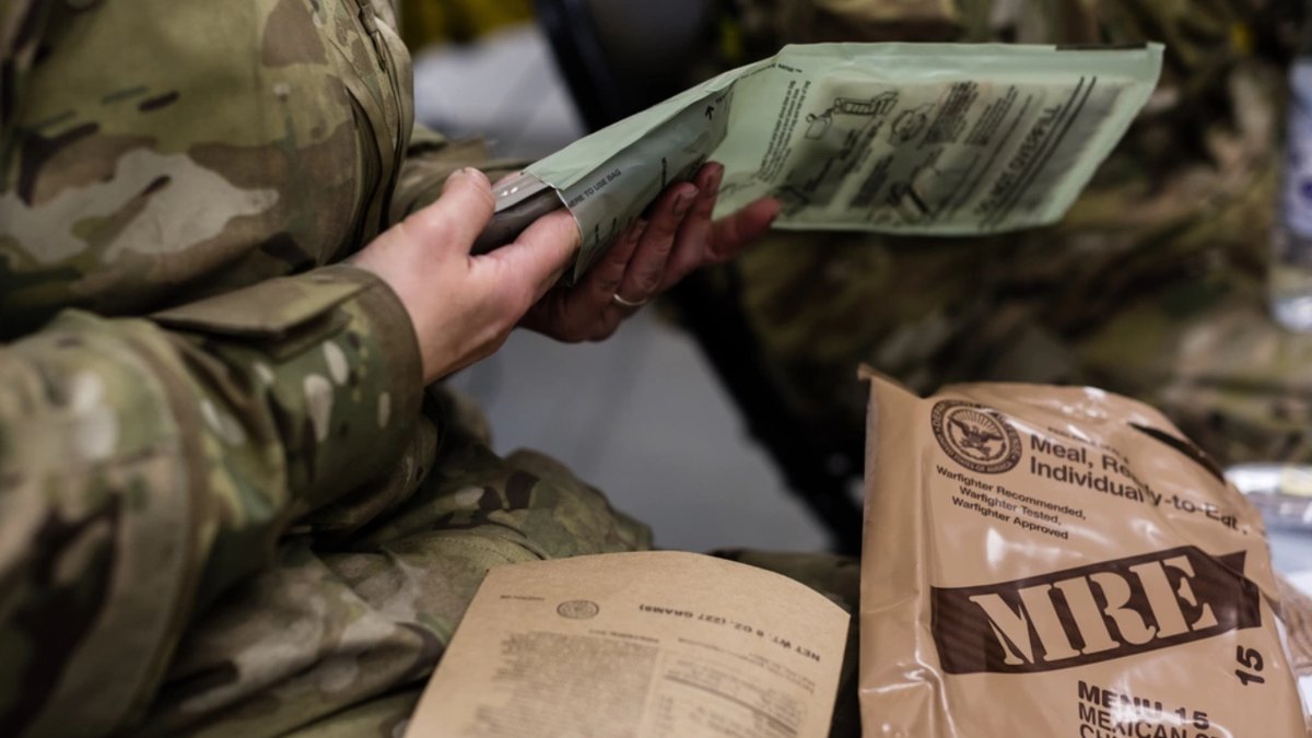 A U.S. Air Force Airman with the 24th Intelligence Squadron Eagle Vision 1 flight opens his Meal, Ready to Eat while participating in exercise Contested Forge '18 at Grostenquin Air Base, France.