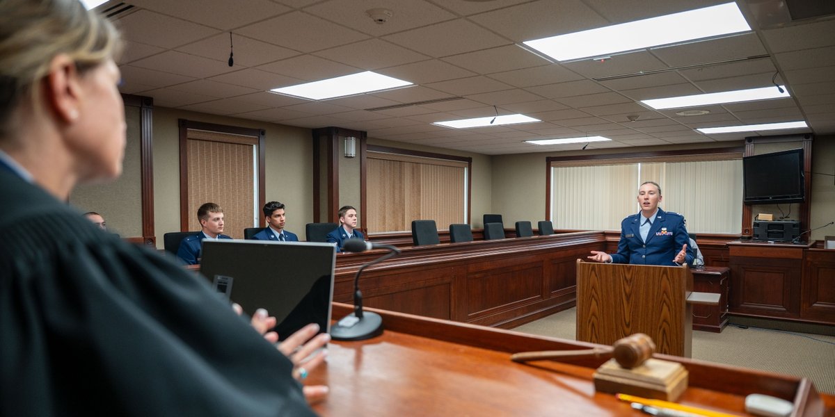 A female lawyer speaks to a judge in a military court.
