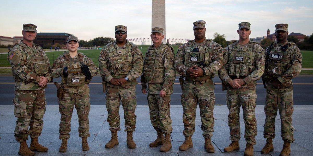 U.S. service members with the 112th Military Police Battalion, Mississippi National Guard, and Joint Force Headquarters, District of Columbia National Guard, take a group photo on the National Mall in Washington, D.C., Oct. 21, 2025.