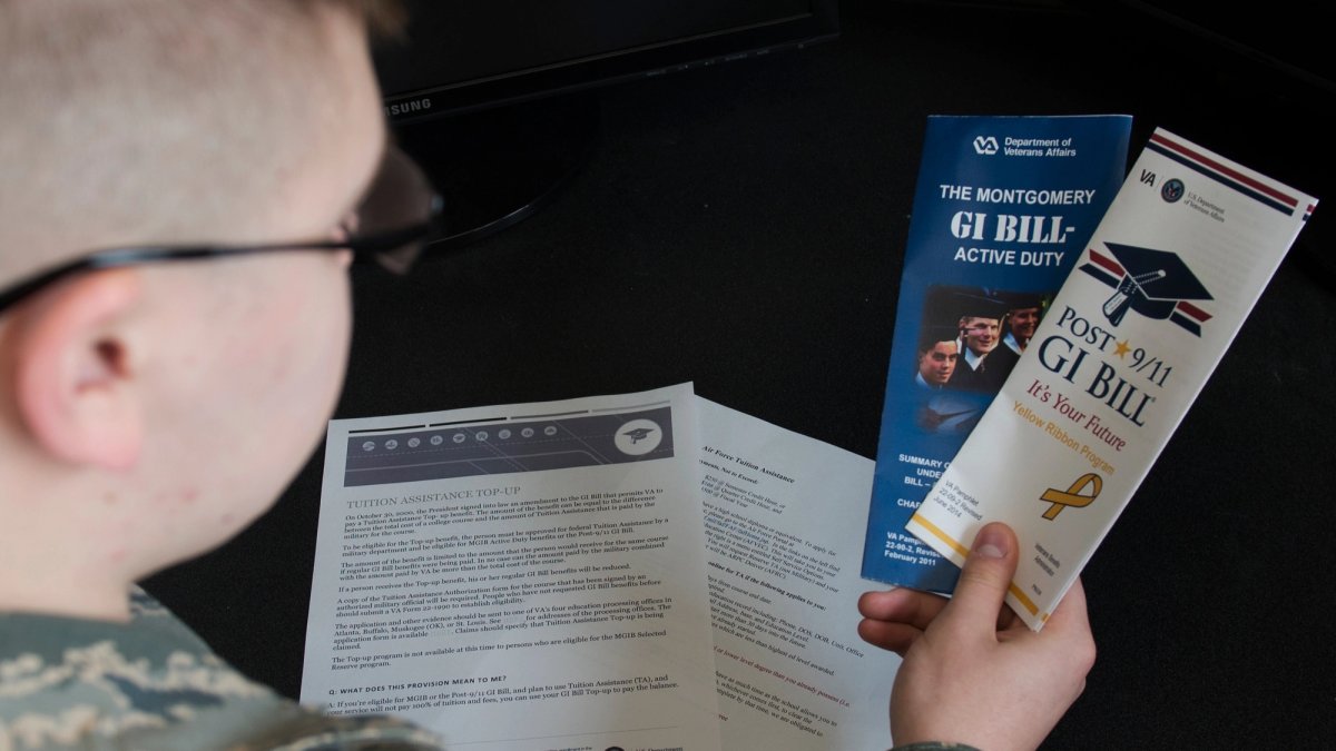 Soldier reads GI Bill brochures.