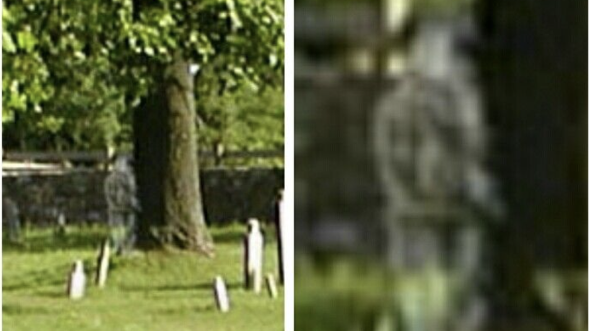 Civil War soldier ghost near cemetery tombstones and tree