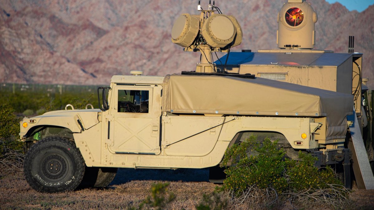 Military vehicle with battle laser equipment mounted on top.