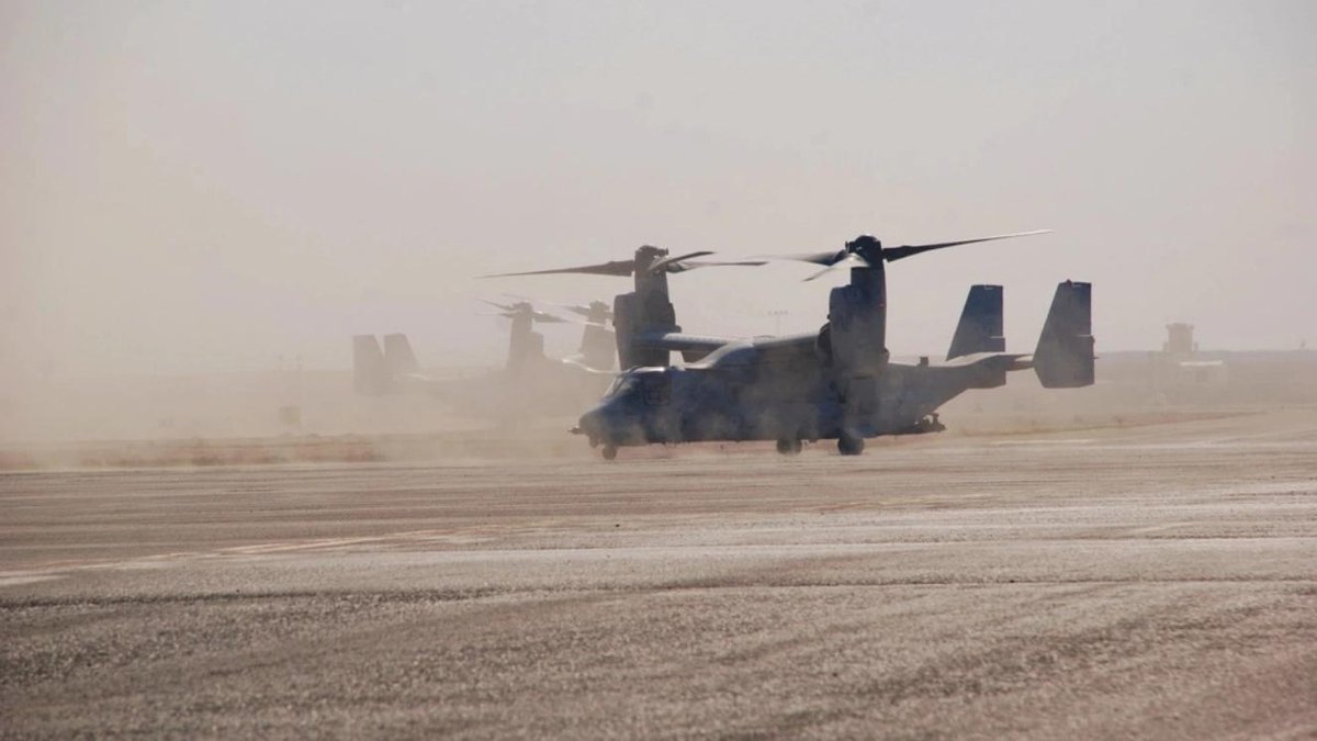 Air Force CV-22 Osprey aircraft on dusty airfield ready for operations.