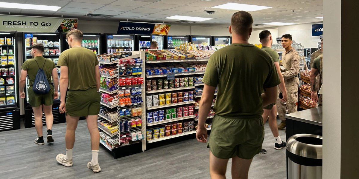 Servicemen shop in a new mini market.