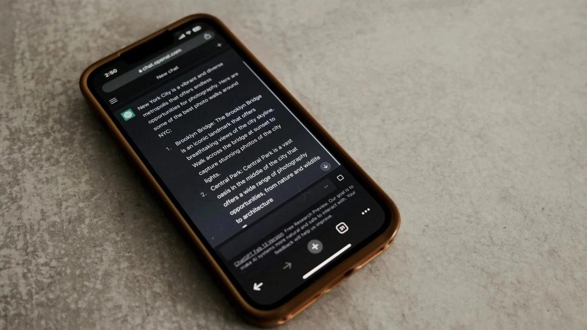 Smartphone displaying text about AI technology on a table, relating to Air Force operations.