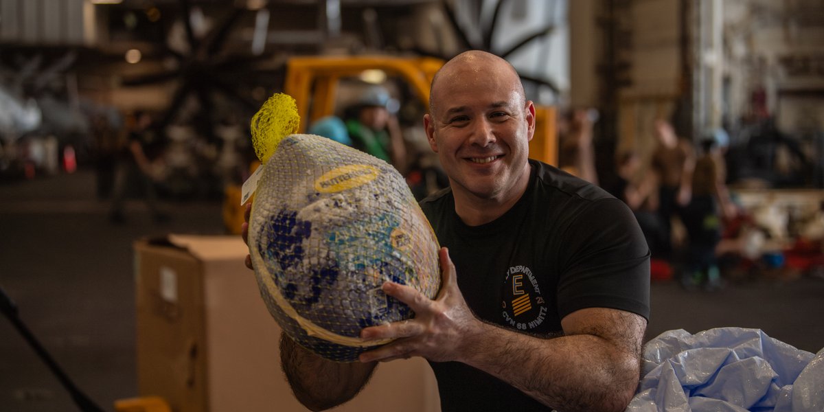 U.S. Navy Chief Warrant Officer 2 Angel Melendez, the Food Service Officer of the Nimitz-class aircraft carrier USS Nimitz (CVN 68), receives pallets of turkeys during a replenishment-at-sea in preparation for a Thanksgiving celebration in the Philippine Sea, Nov. 22, 2025.
