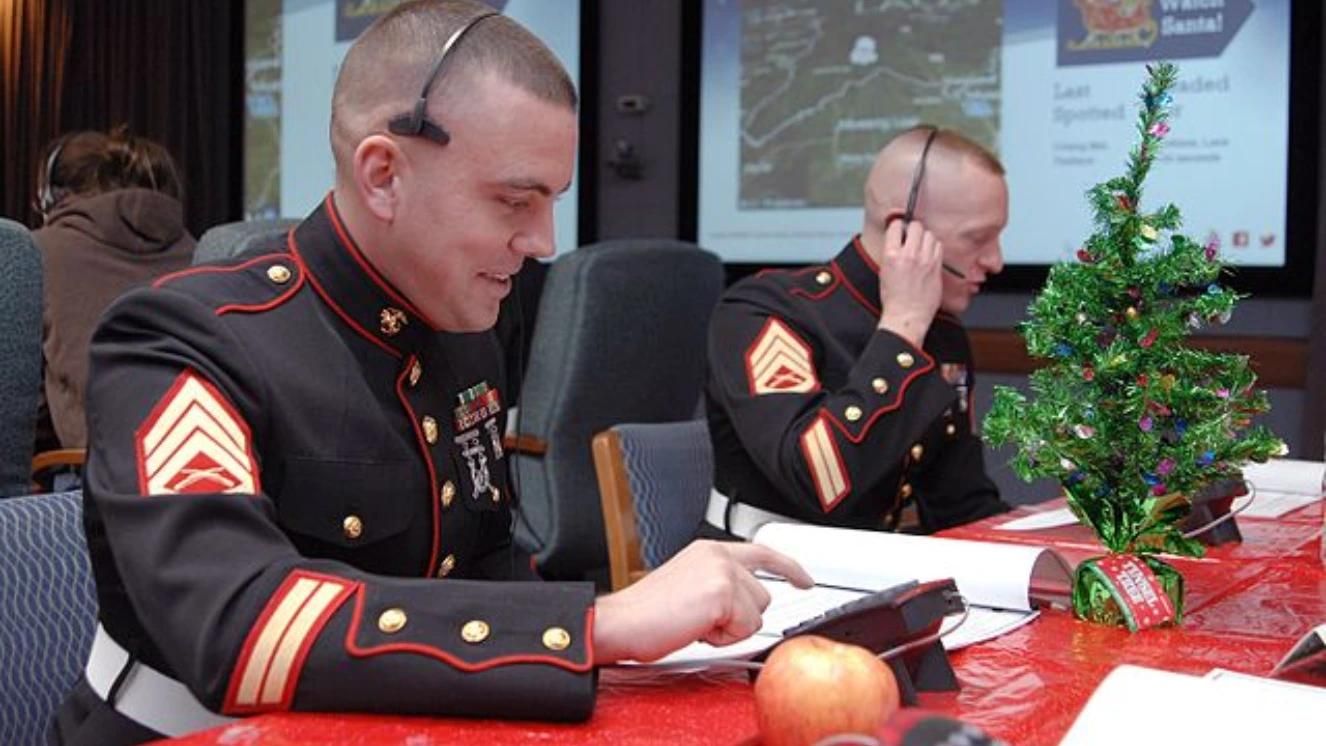 Marines tracking Santa at NORAD operations center, holiday decorations on table