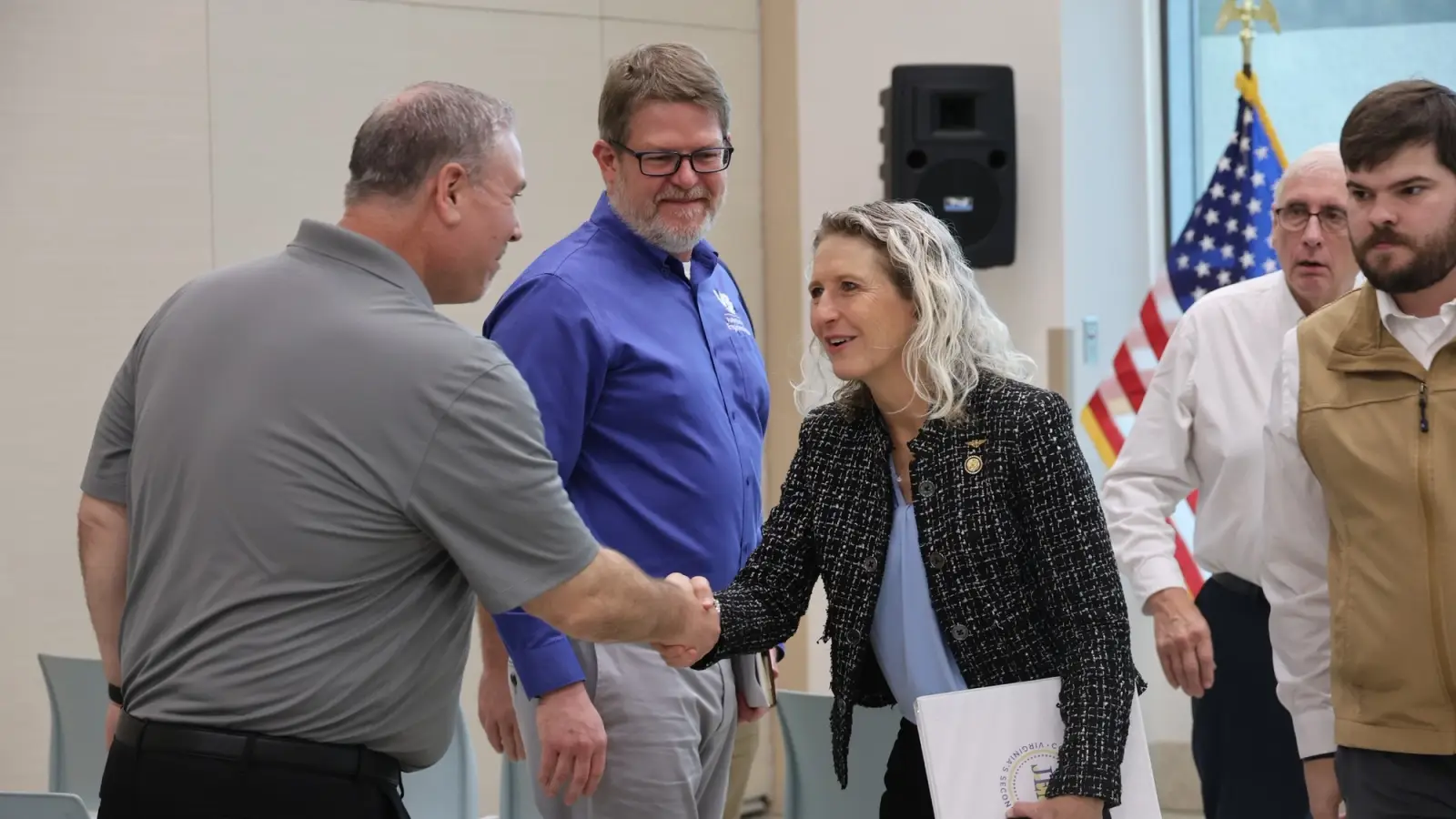 Rep Kiggans shakes hands at a military visit.