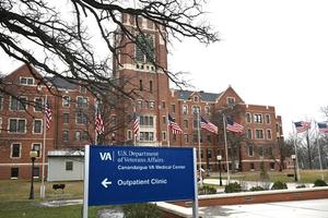 VA Outpatient Clinic sign outside of old brick bldg.
