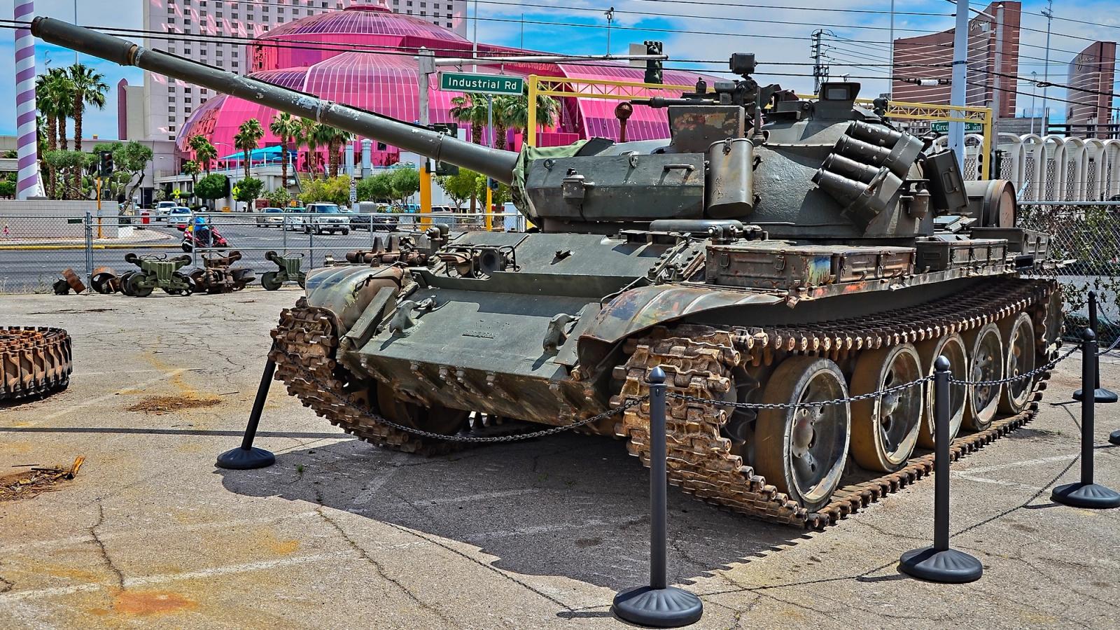 A vintage military tank in a museum yard with Vegas strip in the background.