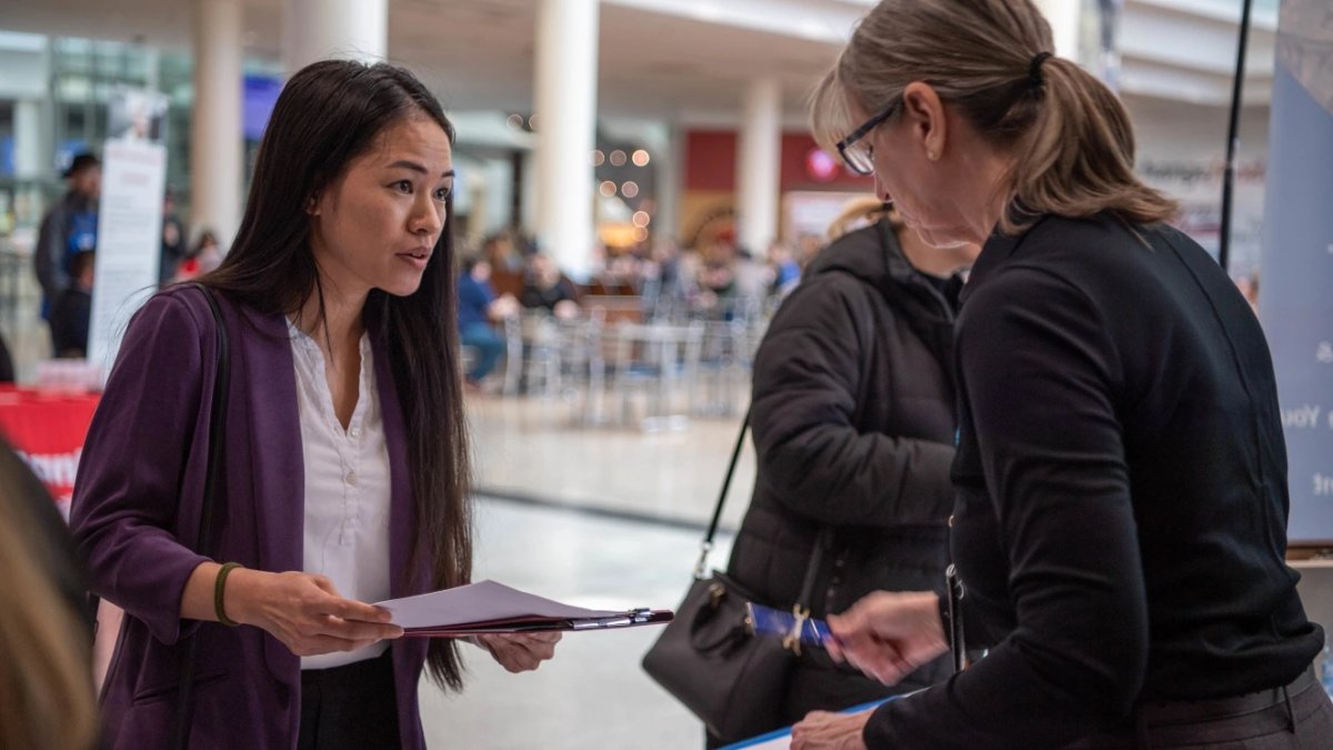 A military spouse looks over available positions at a job fair held at Ramstein Air Base.