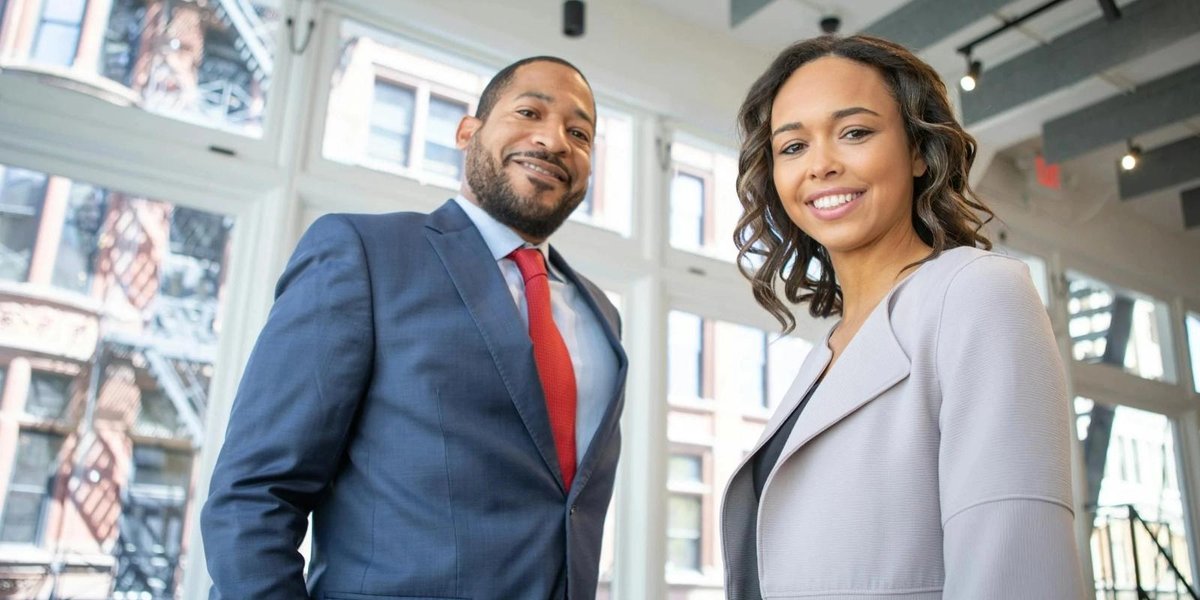 Service members in business attire standing in a modern office setting.