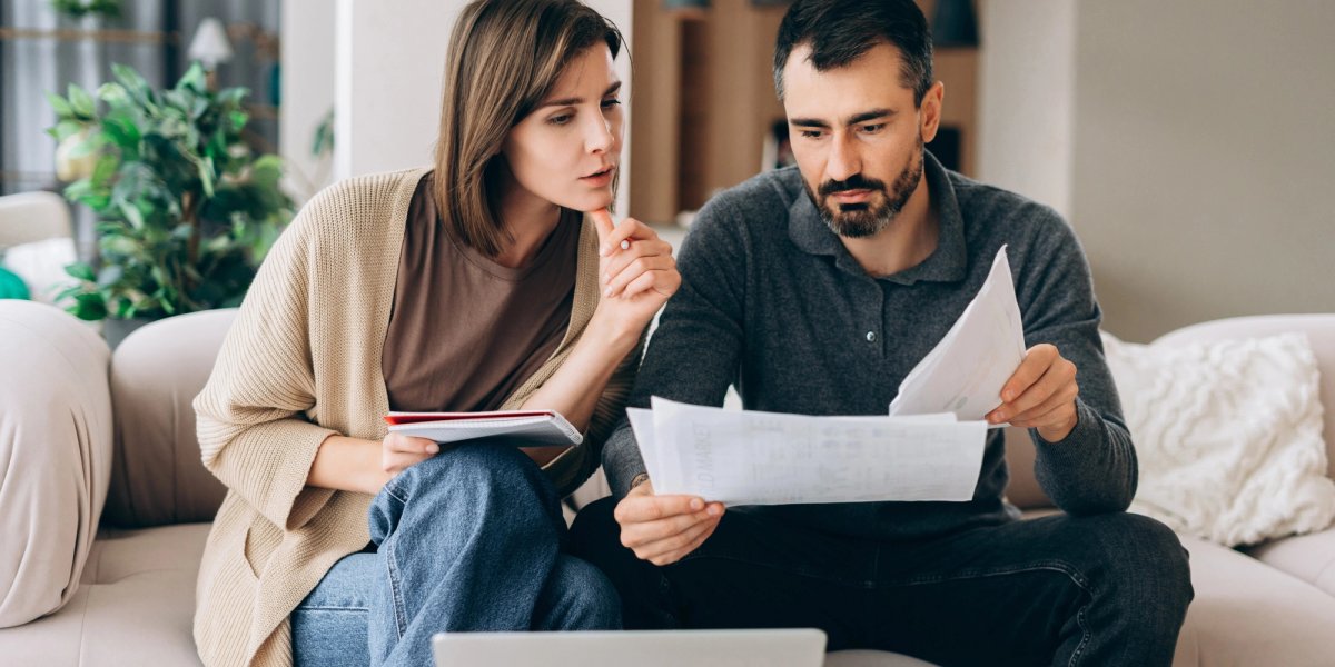 A couple mulls over financial decisions.