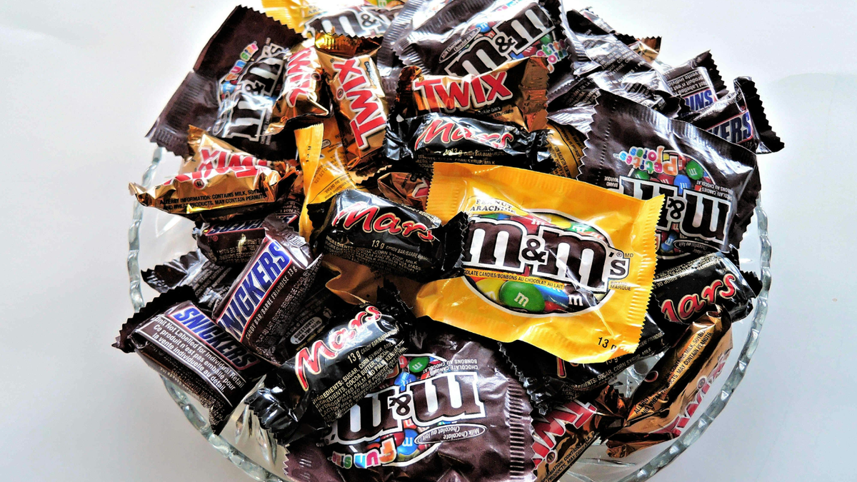 A variety of chocolate bars in a glass bowl.