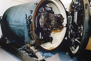 Nuclear warhead with a door open to see coiled wires.