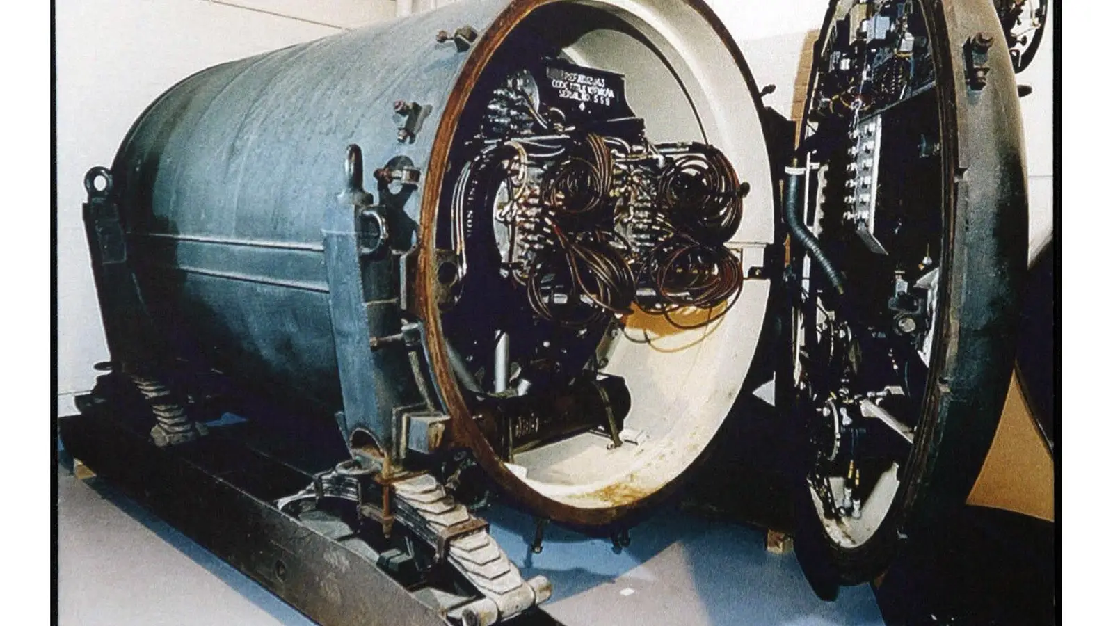 Nuclear warhead with a door open to see coiled wires.