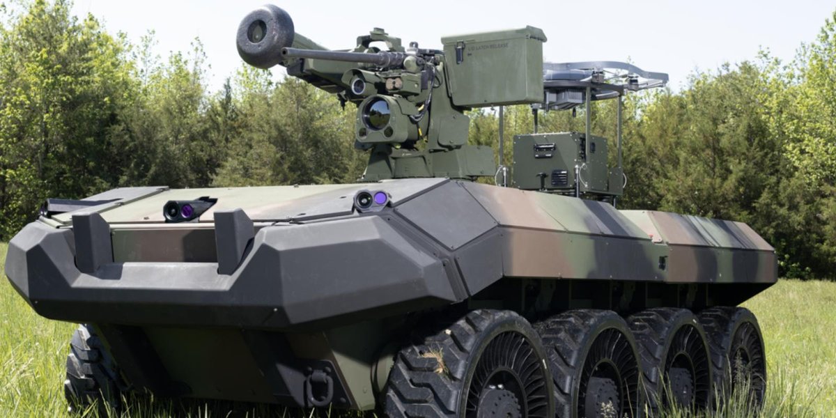 Army's WOLF-X robotic combat vehicle in grassy field with forest backdrop
