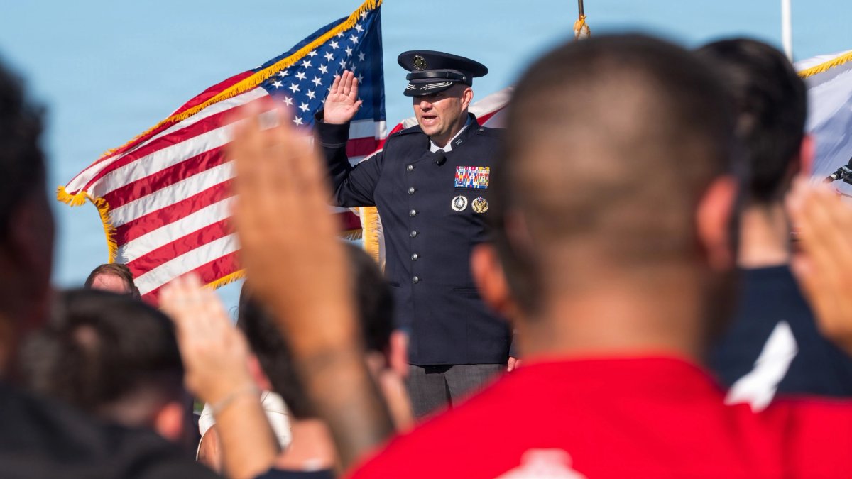 A senior officer salutes new recruits to the Space Force.