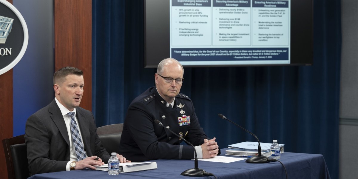 Officials sitting at a table at the Pentagon.