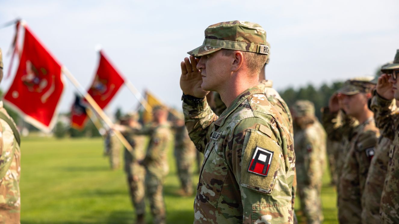 A U.S. Army Soldier assigned to 181st Infantry Brigade (Multifunctional Training Brigade), First Army Division East, salutes the flag while the National Anthem plays during the brigade’s Change of Command Ceremony at Fort McCoy, Wisconsin, August 5, 2025.