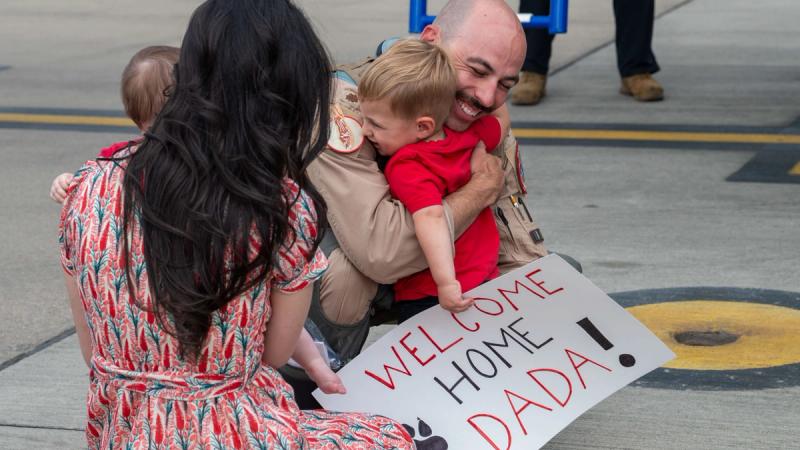 U.S. Air Force Maj. Alan Acosta, 494th Fighter Squadron pilot, reunites with his wife and kids upon returning from a deployment at RAF Lakenheath, England, Aug. 22, 2025. 