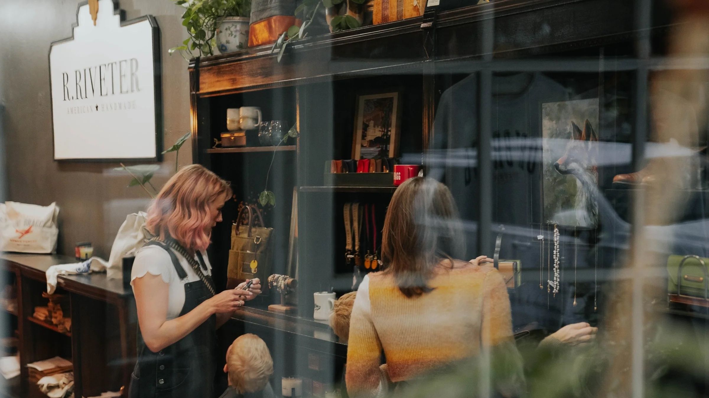 Interior of the R. Riveter store as two women shop.