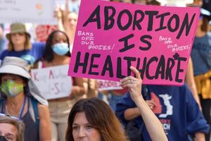 Pro-choice demonstrators hold up signs.