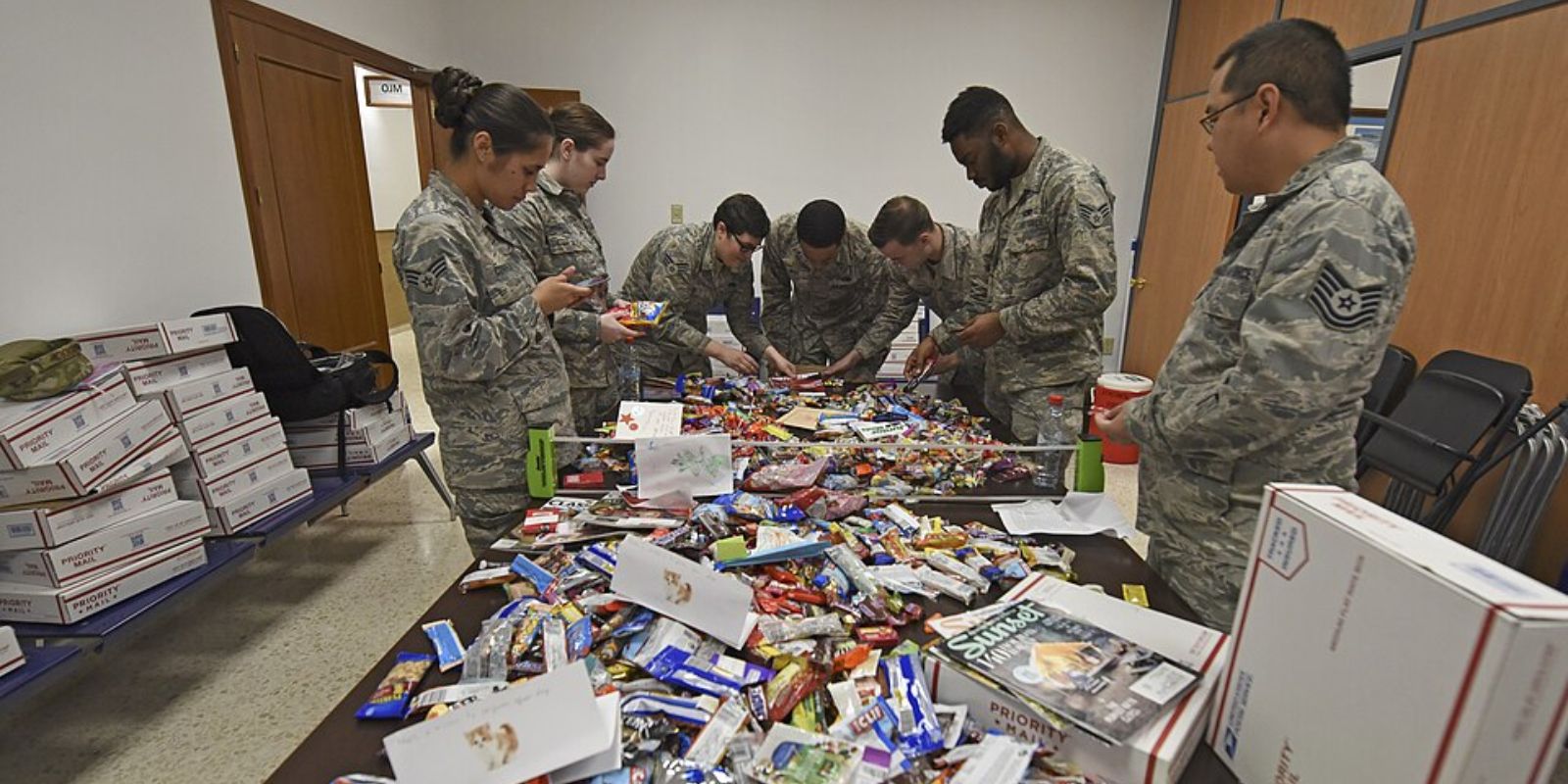 Team Fairchild Airmen stationed abroad open a Treats for Troops package Dec. 4, 2018, at Morón Air Base, Spain.
