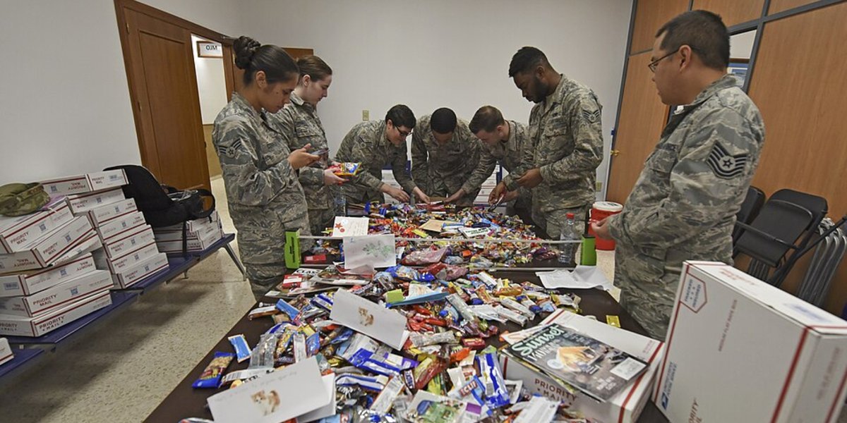Team Fairchild Airmen stationed abroad open a Treats for Troops package Dec. 4, 2018, at Morón Air Base, Spain.