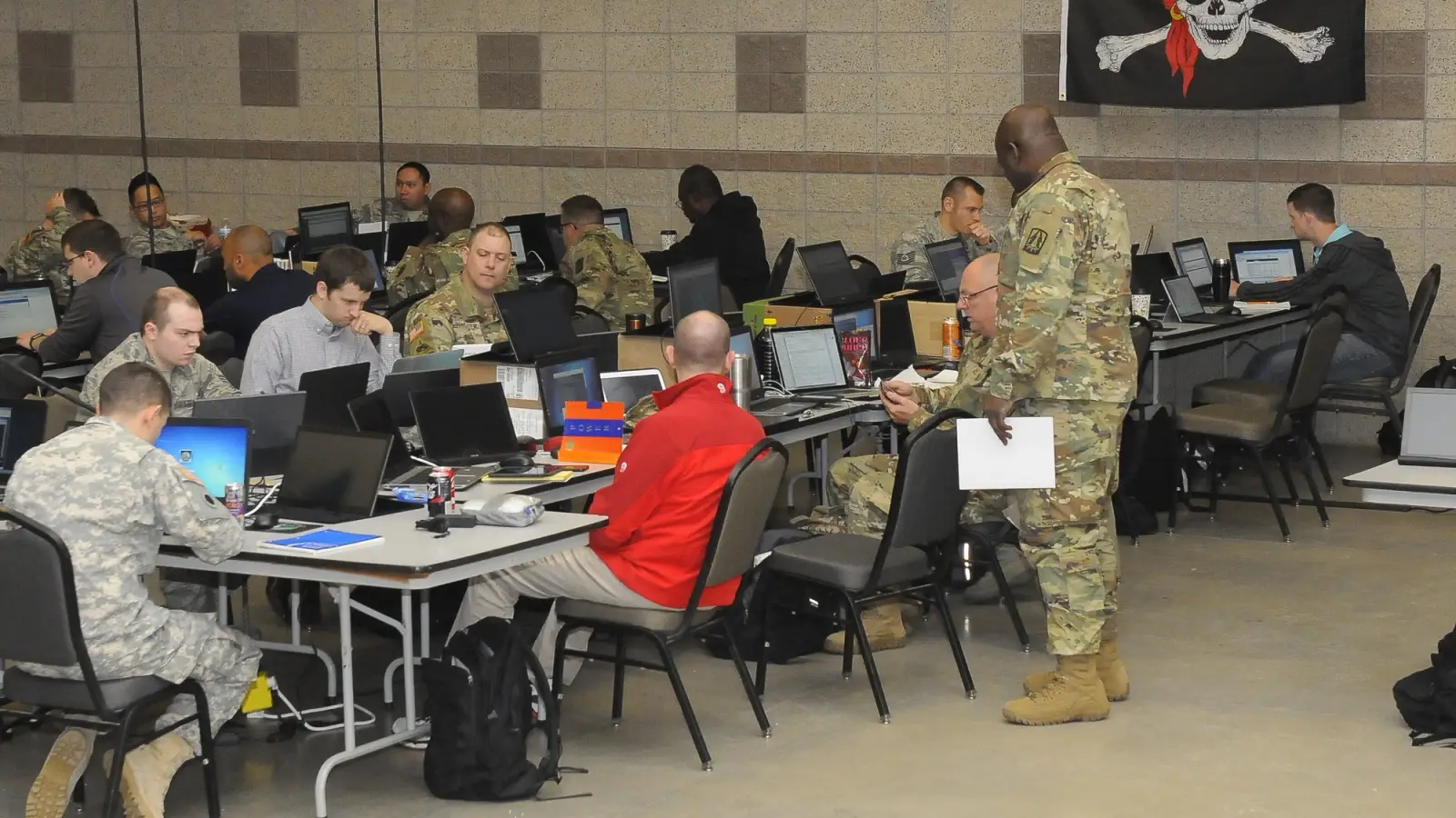 Civilians and reservists work in a cybertraining class.