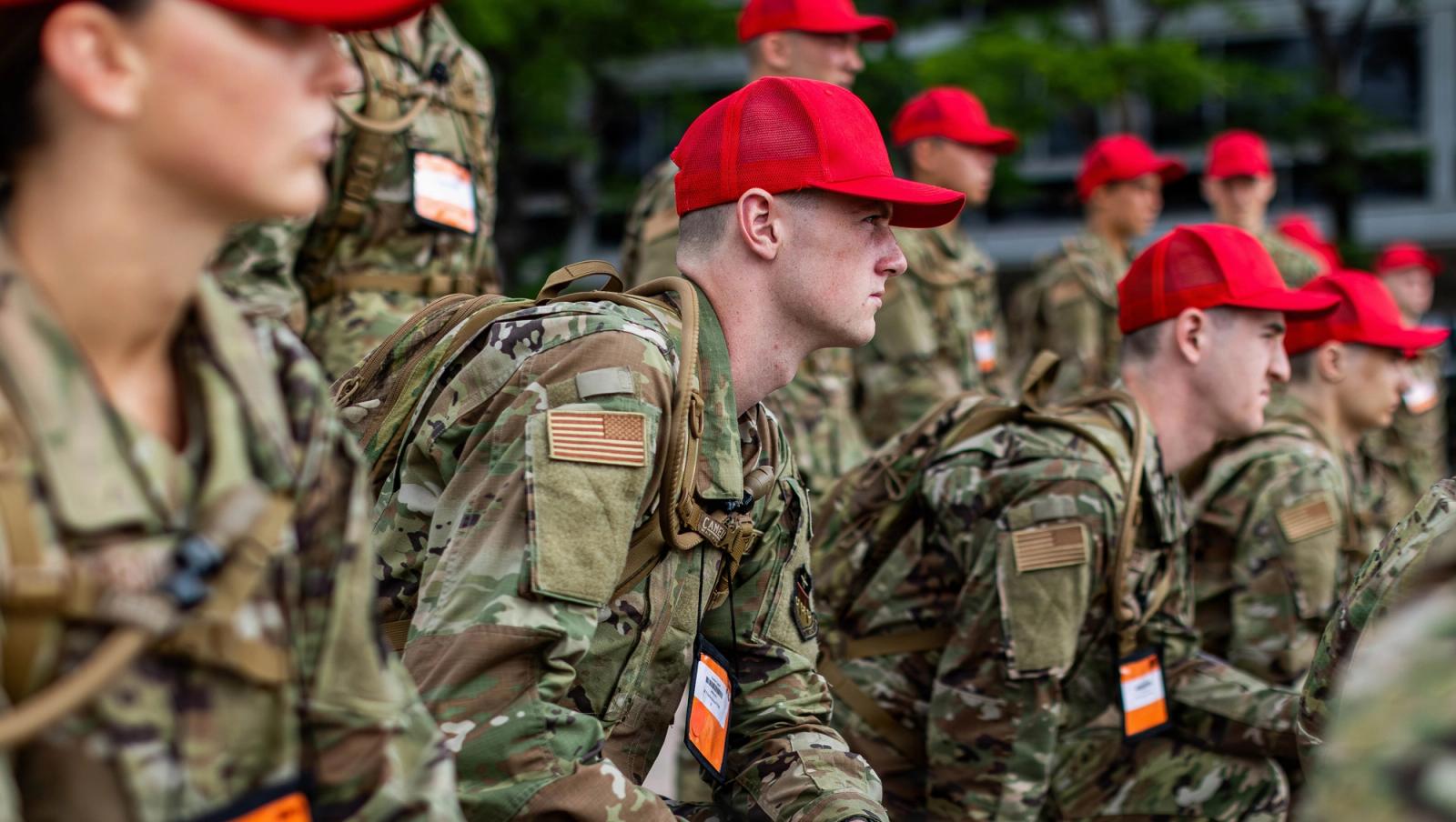 Group of new recruits list intently to instruction.