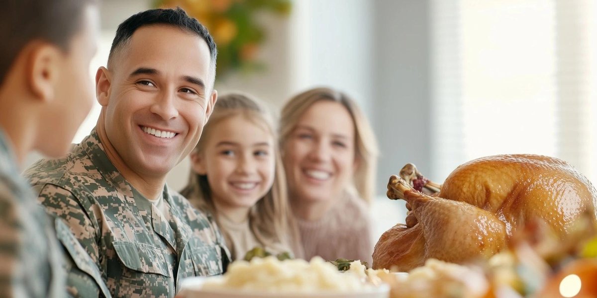 Army servicemember smiling with family at Thanksgiving table with roast turkey