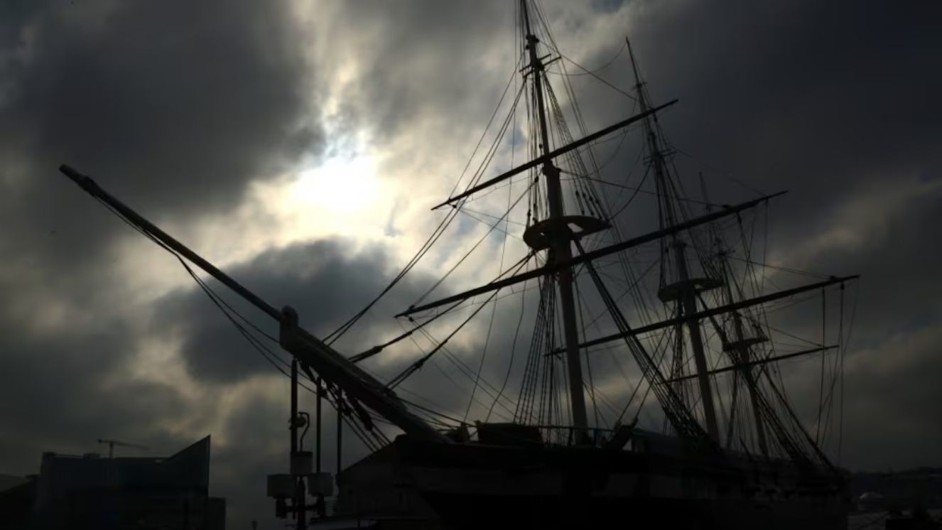 The sun breaks through the morning gloom to illuminate the USS Constellation at dock on the Baltimore Harbor during a Defense Information School photojournalism exercise March 4, 2016, Baltimore.