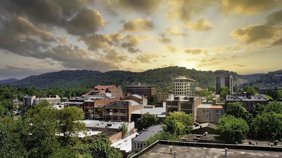 Downtown Asheville skyline with mountains and sunset in North Carolina